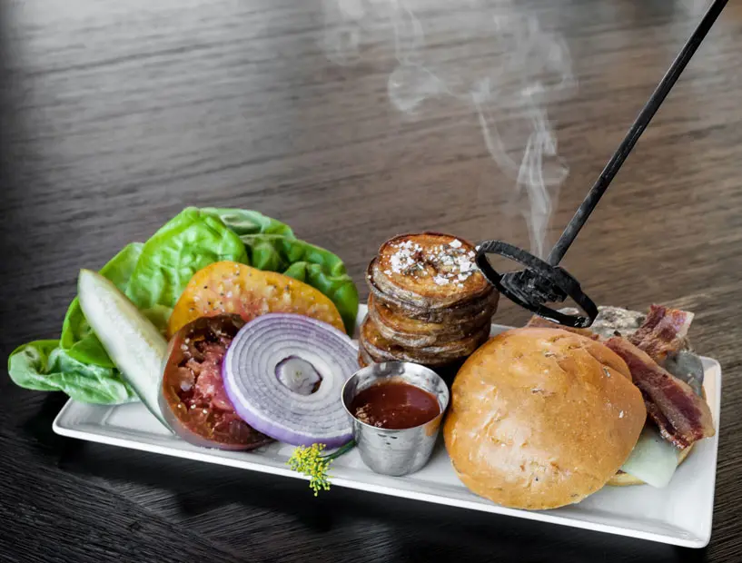 Indulge in a decadent hamburger at Radio Milano's Summer Grilling Series. 
