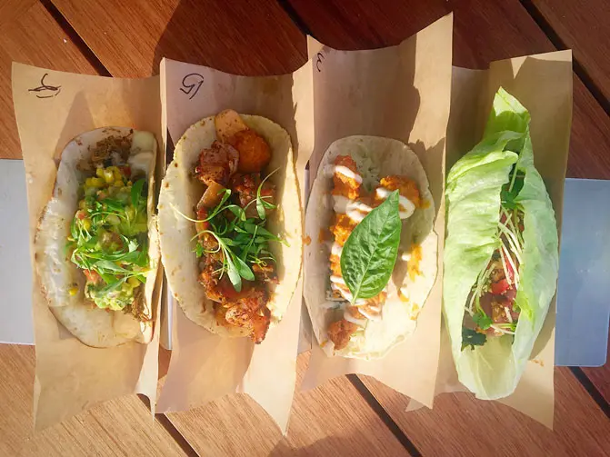 From left: slow roasted brisket taco, shrimp and grits taco, crisp tikka chicken taco, ahi poke taco 