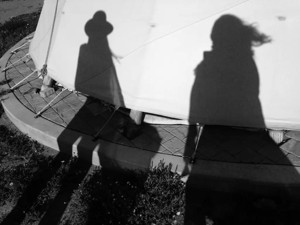 Our shadows against teepees at El Cosmico 