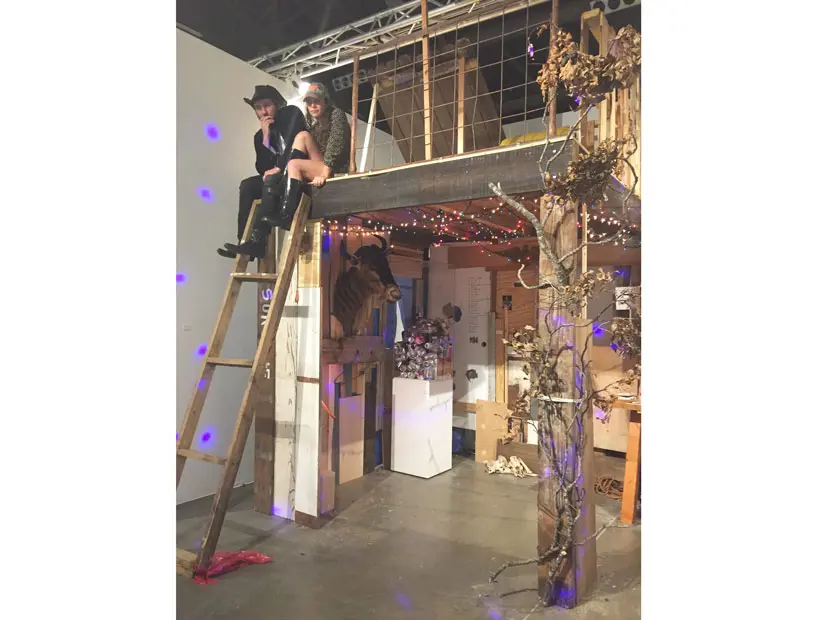 Paul Middendorf and Lina Dib cavort at the Art League's booth, which channeled a deer blind.