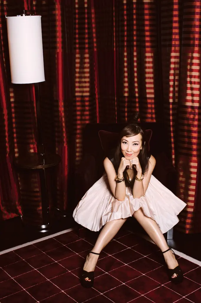 Maison Margiela leather jersey bodysuit $785, Christian Dior pink pleated short skirt $2,600, Anita Ko Panther necklace $5,880, Saint Laurent pumps $995, all at Forty Five Ten.