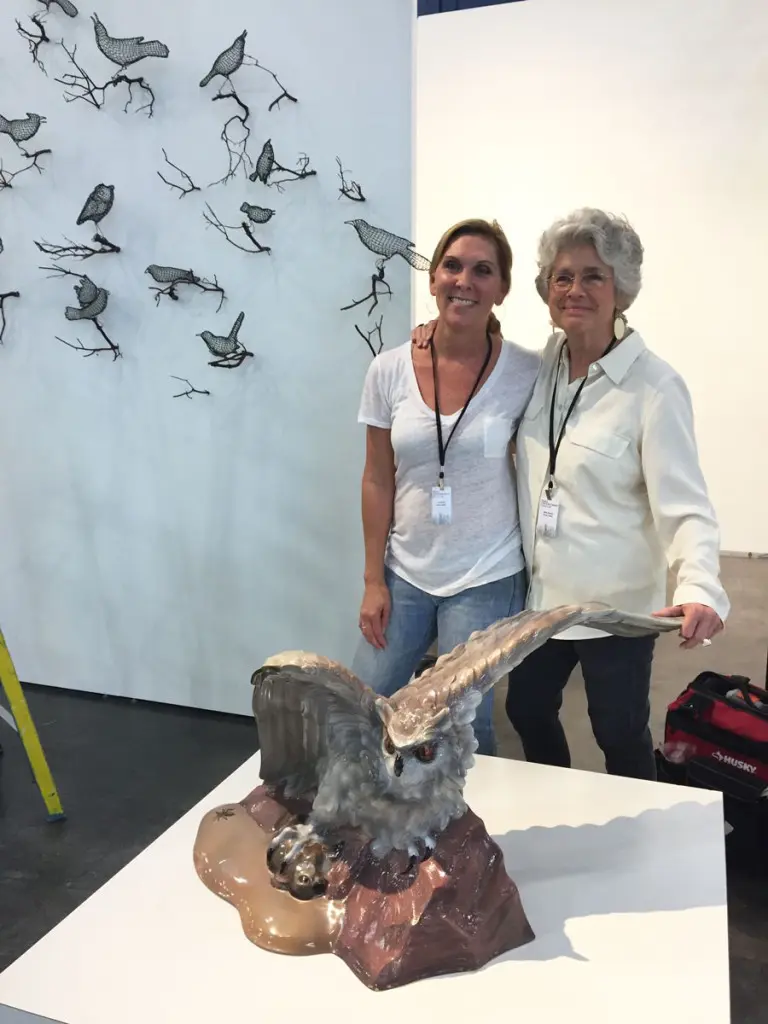 Lee Steffy and Betty Moody, in the Moody Gallery booth, with avian-themed works by Helen Altman (wall) and the late Luis Jimenez (the fierce owl, perfect for a Rice alum).