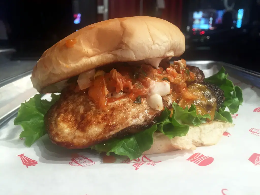The kimchi burger is topped with caramelized kimchi, a fried egg, cheddar and garlic mayo. 