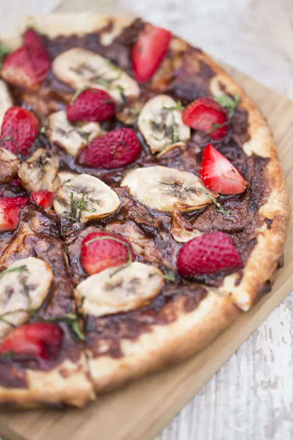 B&B's good morning pizza is topped with nutella, sliced strawberies & bananas. 