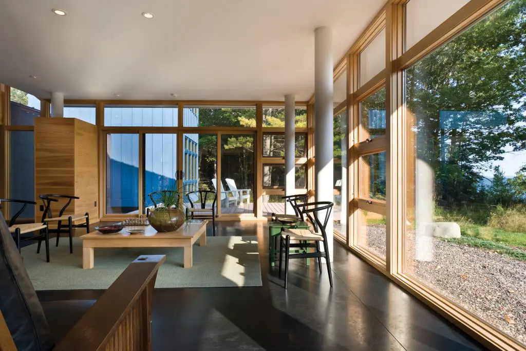 Andersen® E-Series awning and picture windows with Pine Andersen E-Series Picture Windows with pine interiors are right at home in this woodsy retreat. 