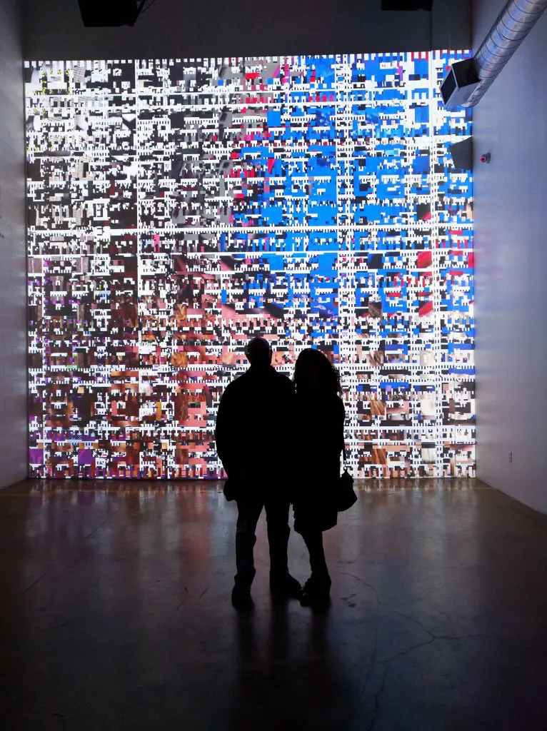 Day For Night served up a curated selection of esteemed musical talents — Philip Glass to New Order — matched by light-based artworks curated by Manhattan creative entity Work-Order, led by Alex Czetwertynski. Shown: Festival mastermind Omar Afra and wife, Andrea, contemplate Casey Reas / Thom Rugo's hypnotic generative sight/sound collage. (Photo Matthew Ramirez)