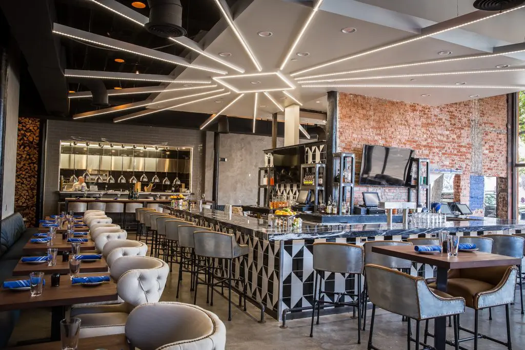 The restaurant features exposed brick walls and polished concrete floors.