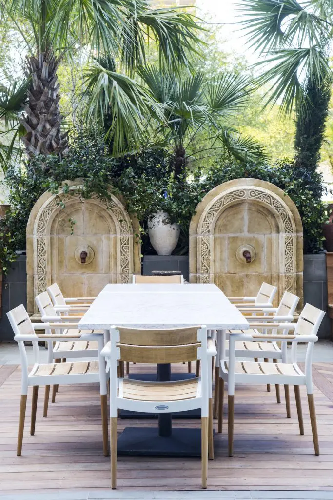 Engulfed in palm trees, the patio is an urban oasis.