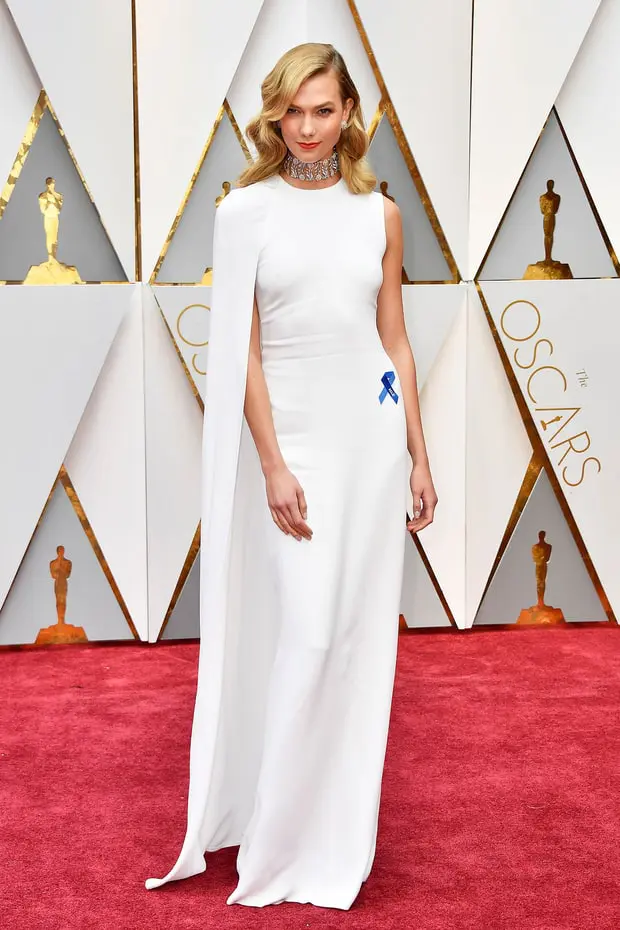Stella McCartney dress, Nirav Modi jewelry, and carrying a Roger Vivier clutch