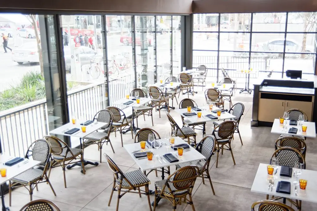 Dine in Brasserie du Parc's indoor-outdoor dining room. 