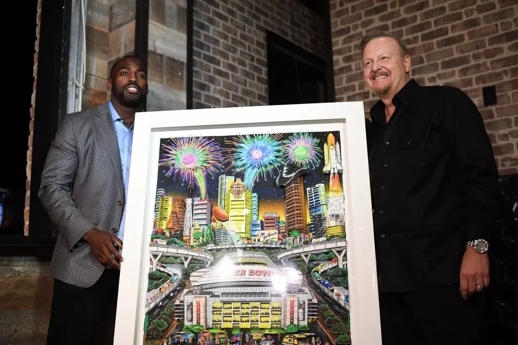 Whitney Mercilus and Charles Fazzino unveil Fazzino's officially licensed Super Bowl LI commemorative 3-D painting. 