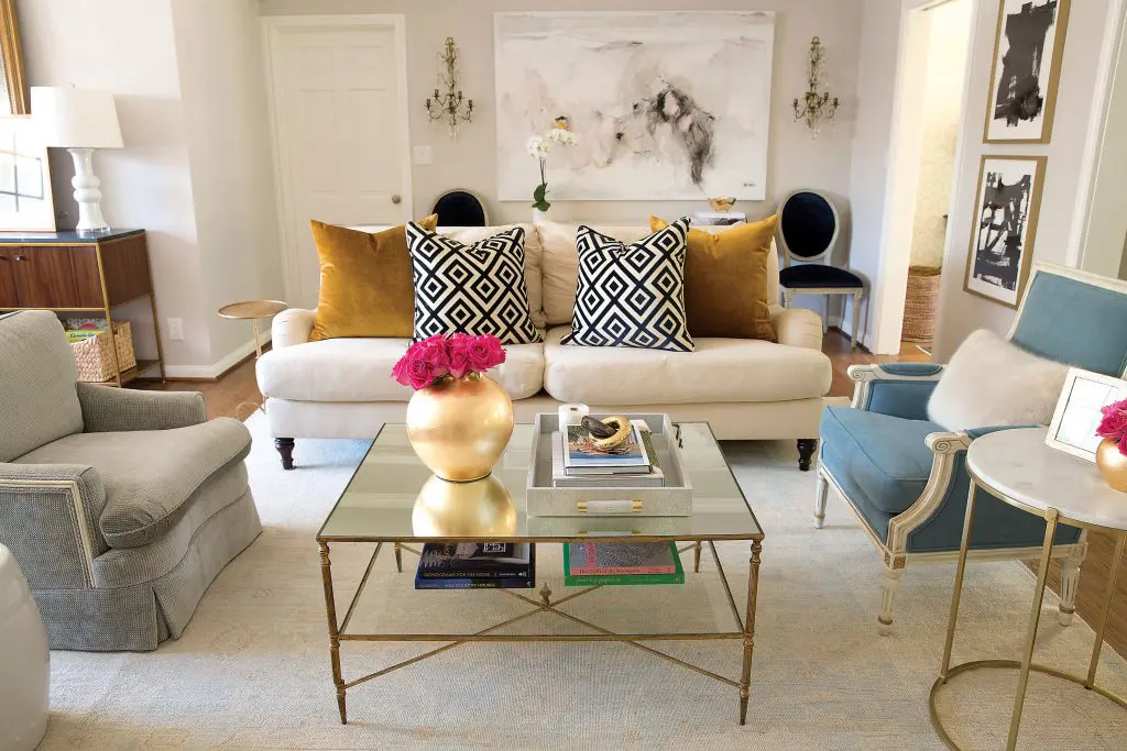In the living room, an oversized painting by Saba Jawda. David Hicks La Fiorentina and mustard velvet pillows. Sets of inherited reupholstered chairs.