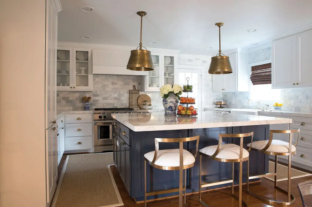 A partnership with Lowe's and KitchenAid resulted in a stunning new kitchen. Island paint color Benjamin Moore Hale Navy.  Counter stools by Wisteria. Indoor/outdoor rug by Floor.