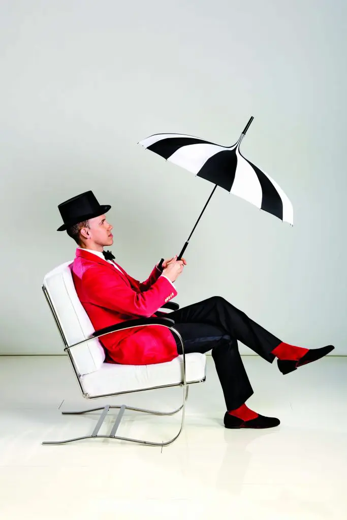 Miles Redd sits pretty in the Duke lounger for Ballard Designs