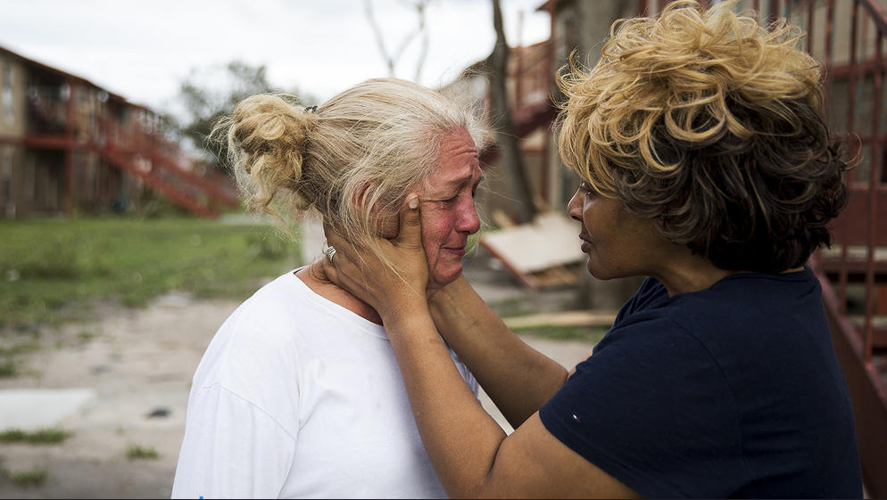 Lifelong friends comfort each other in Refugio, Texas. (Photo by Nick Wagner / Austin American-Statesman via AP) 