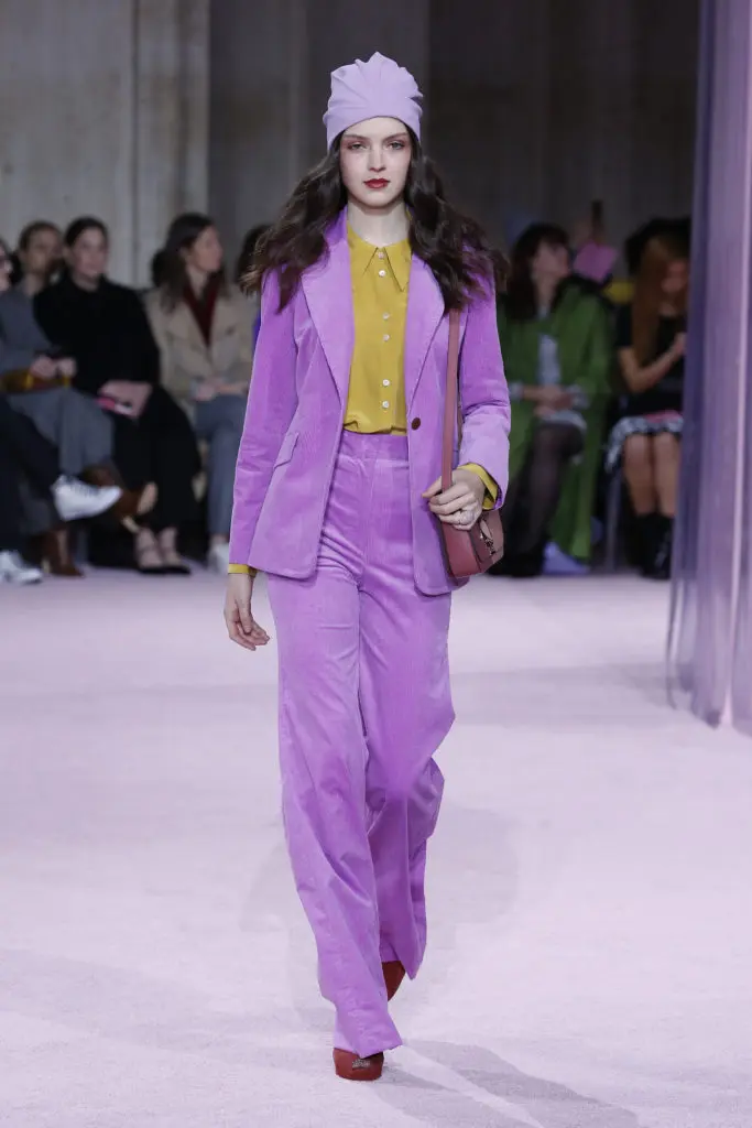 Kat Spade New York pink corduroy pantsuit, marigold blouse, lavender turban. (Photo by Kate Spade New York)