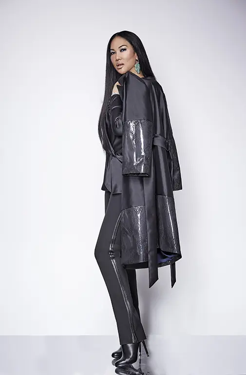 Kimora Lee Simmons models a striped tuxedo pant, gray blouse, and coat with shiny panels from her fall Kimora Lee Simmons collection. (Photo by Kimora Lee Simmons)