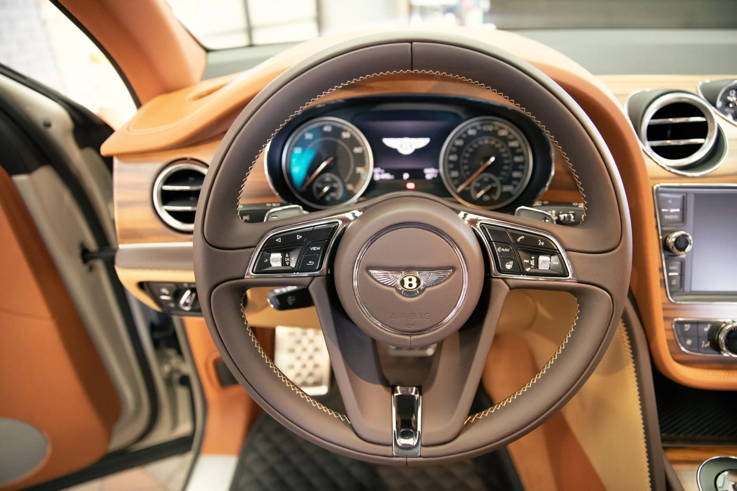A duotone steering wheel has a burnt oak center, and a saddle-leather outer and chrome elements. (Photo by Park Place Dealerships)