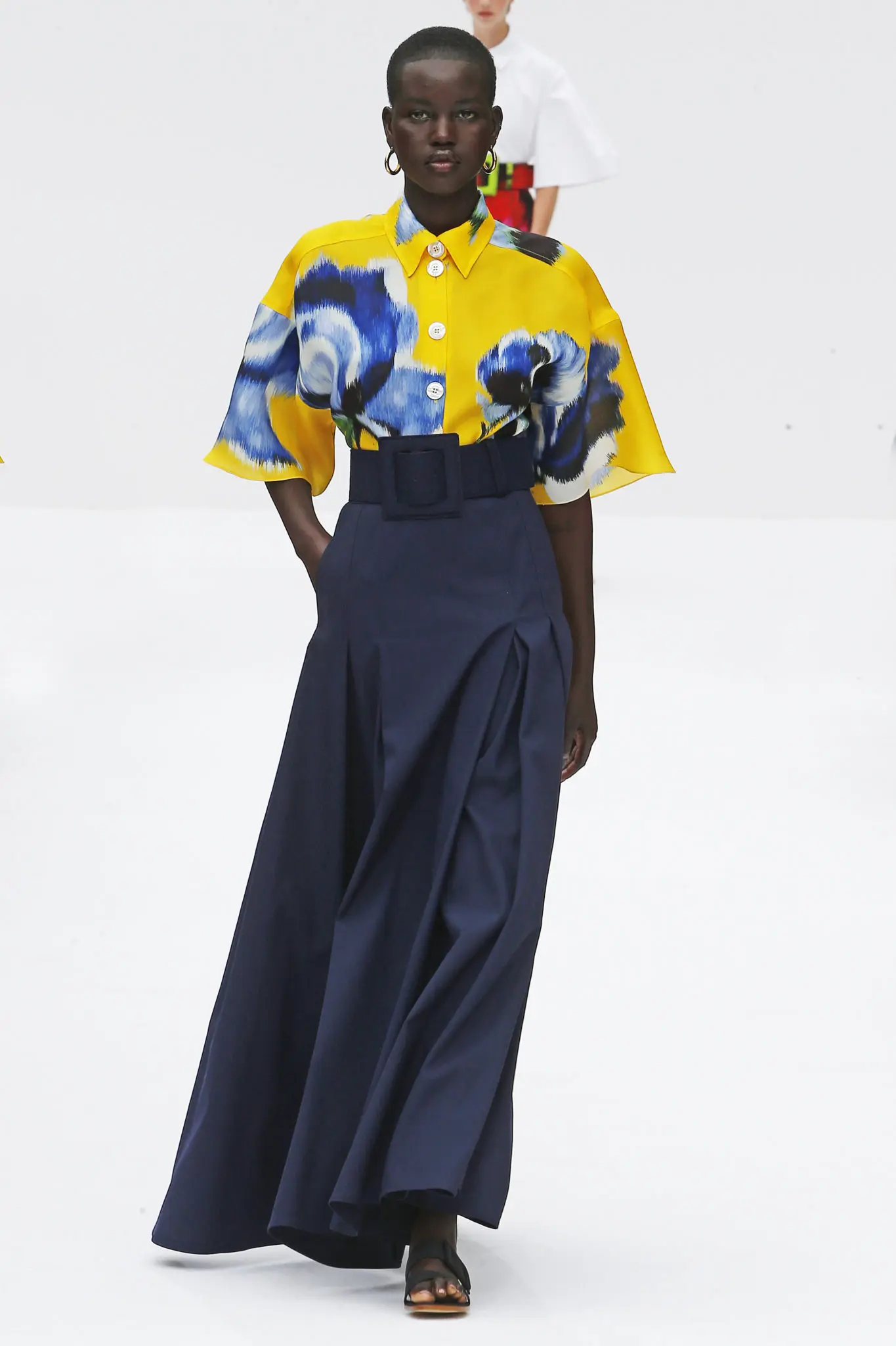 Carolina Herrera taxi cab yellow floral print gazar shirt, midnight cotton twill A-line skirt, and canvas belt. (Photo courtesy of Carolina Herrera)