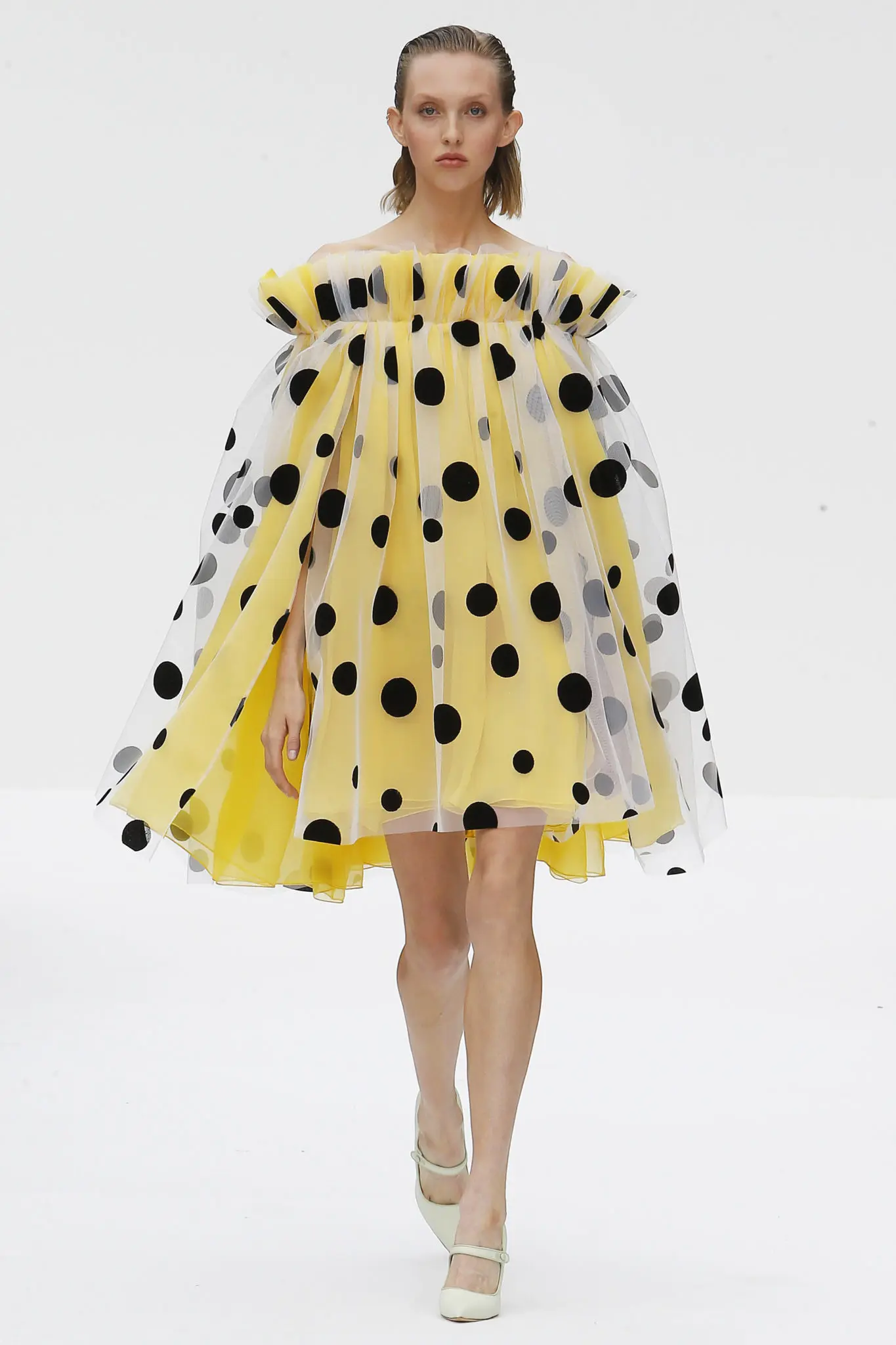 Carolina Herrera white and black polka dot tulle off-the-shoulder cape dress with taxi cab yellow crinkle chiffon underlay. (Photo courtesy of Carolina Herrera)