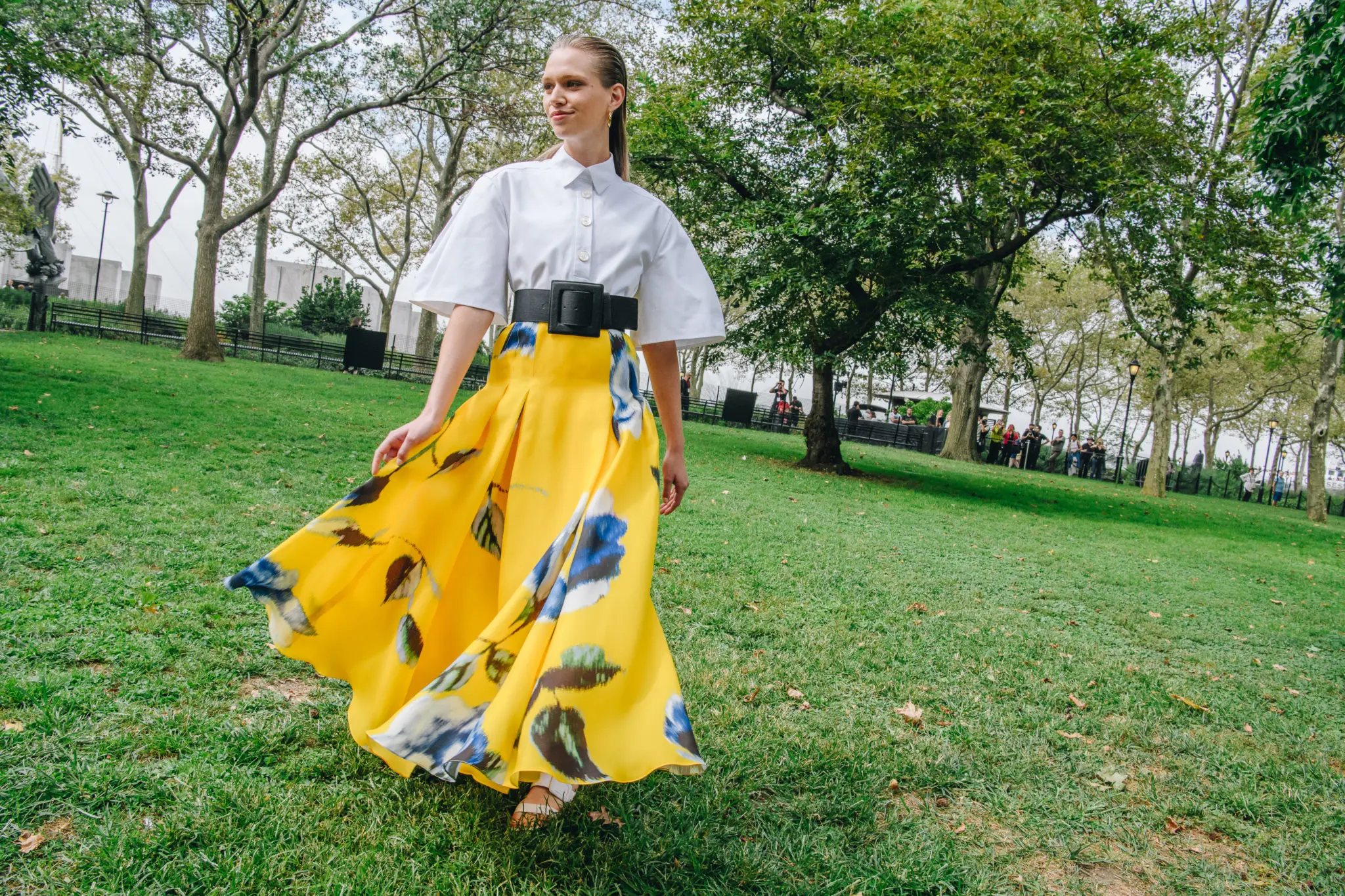 Carolina Herrera white cotton canvas Henley collar skirt, taxi cab yellow floral print gazar A-line skirt, black canvas wide belt. (Photo by Nina Westervelt courtesy of Carolina Herrera)