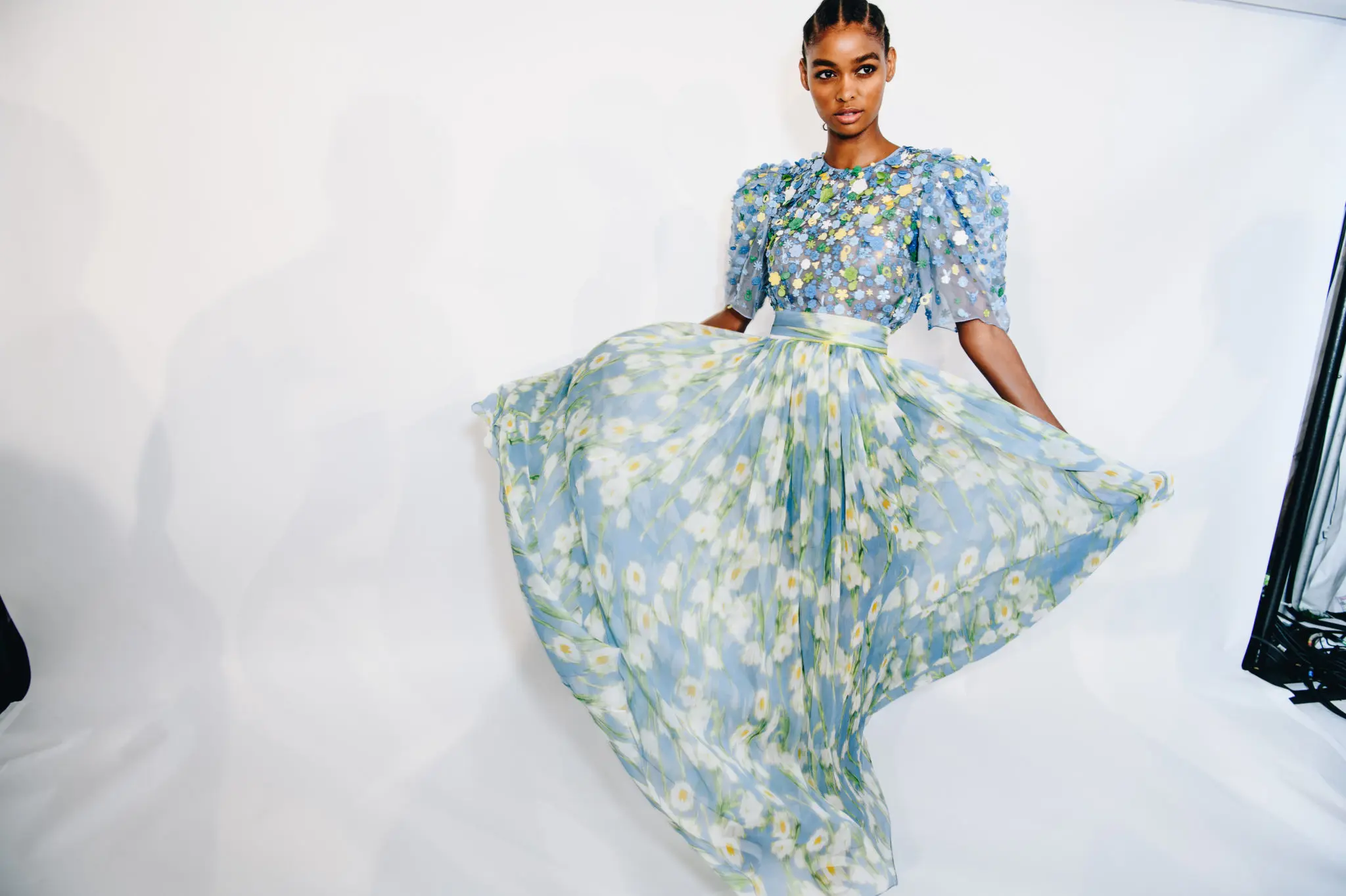 Carolina Herrera cielo blue puff sleeve embroidered blouse. lily of the valley print chiffon gathered skirt. (Photo by Nina Westervelt courtesy of Carolina Herrera)
