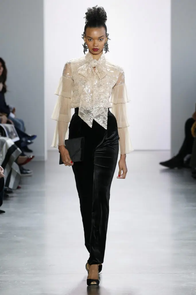 Badgley Mischka tiered chiffon bow blouse and black trousers. (Photo courtesy of Badgley Mischka)