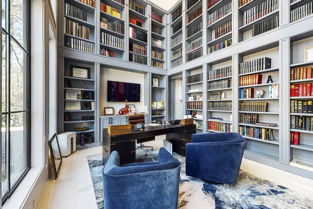 The 10,000 square foot home at 346 Hunters Trail boasts a two-story library that can hold 2,000 books. (Photo by Jason Koonce with Hommati)