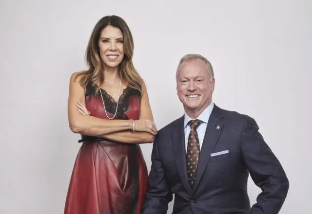 Lori Jones is wearing Alexander McQueen at Neiman Marcus and Eiseman Jewels. Jerry Jones Jr. is wearing his own suit.