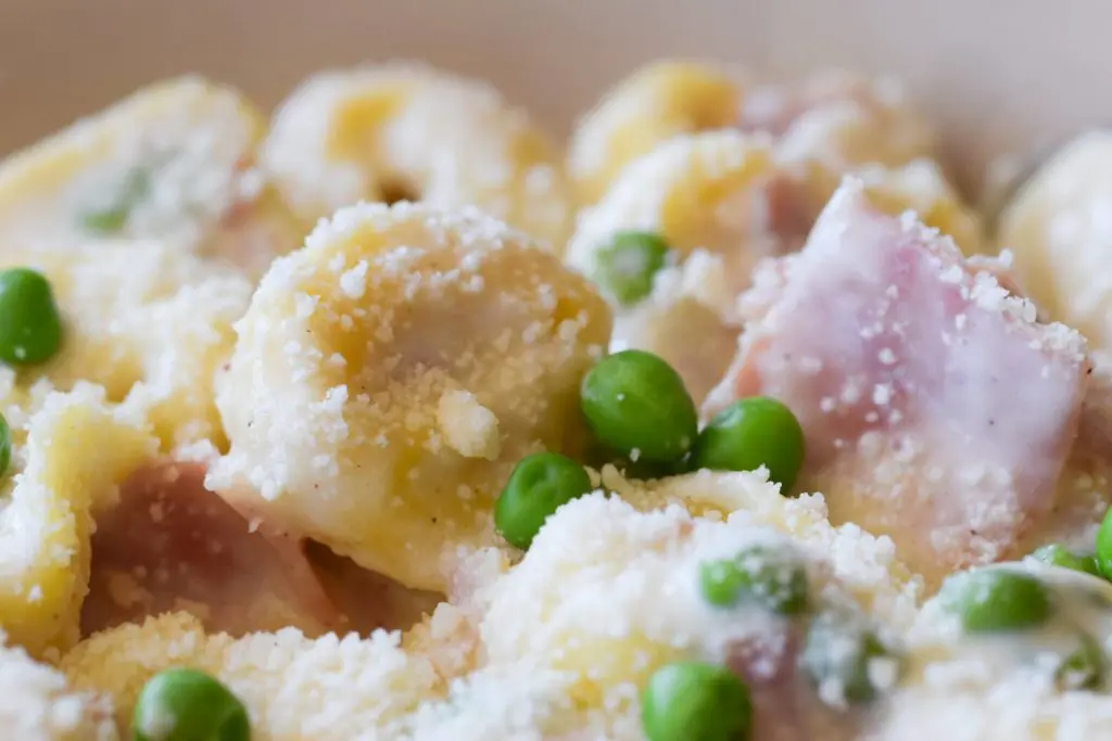 Aventino's - Tortellini Aventino's gets a close-up filled with ham, peas and parmesan cheese.
