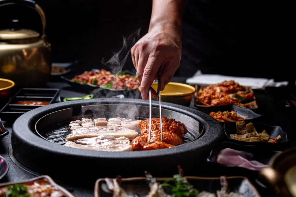 Galbi Pork Belly and Spicy Gangnam Chicken is cooked on the grill at the new Korean BBQ restaurant called Hongdae 33. (Photo by Jenn Duncan)