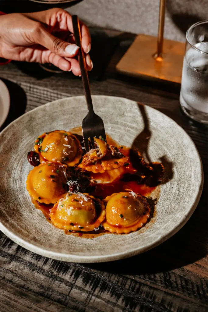 The Brisket and Foie Gras Ravioli served in a cherry reduction is a must-try at The Saint. (Photo by Kayla Enright)