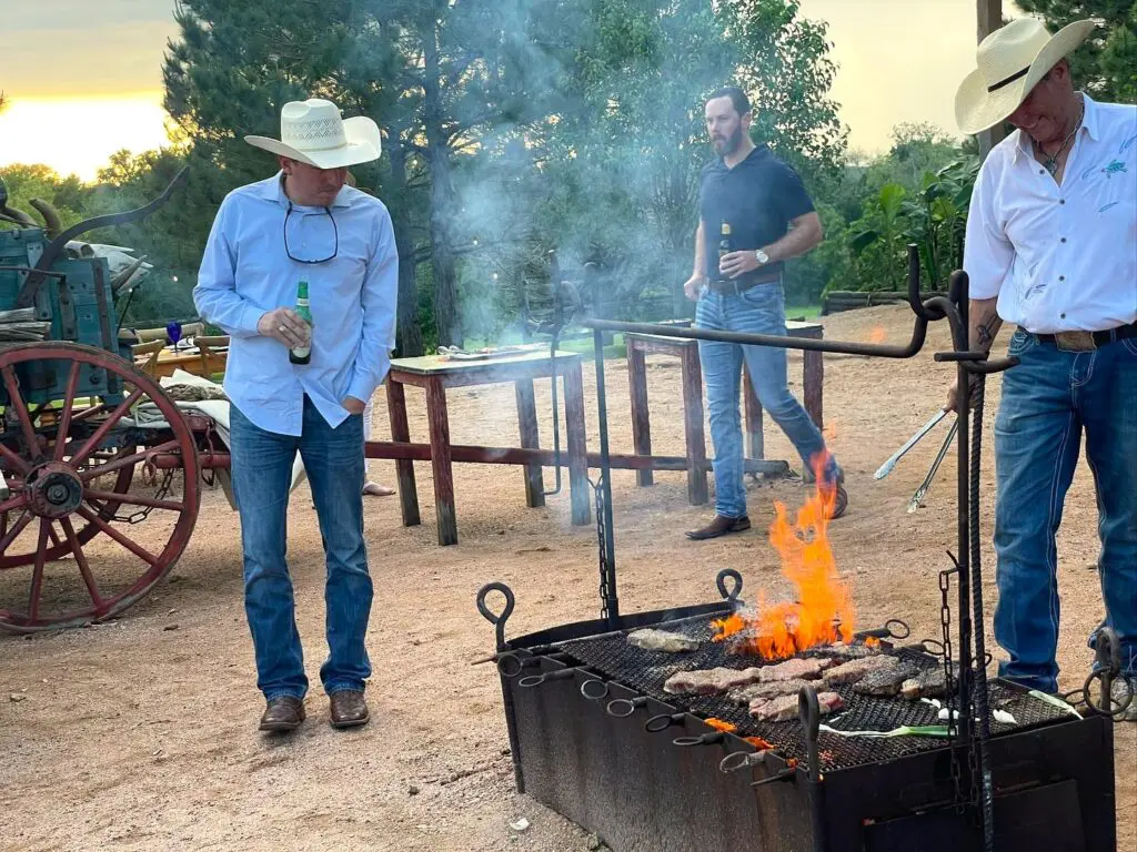 Chef Grady Spears grills over open flame for an event at Texas Ranch Life.