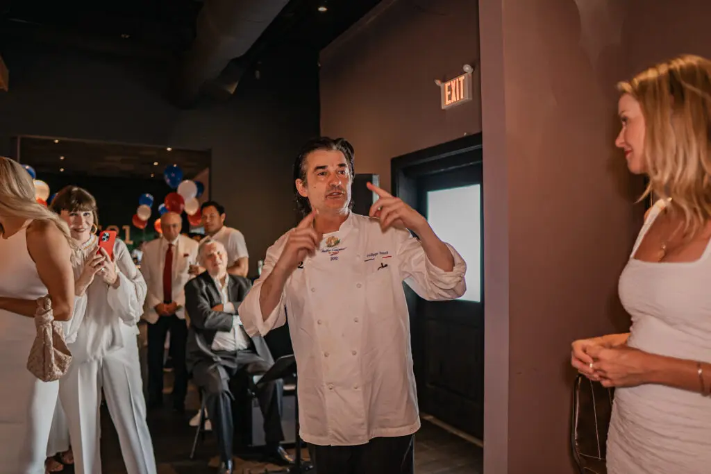 Chef Philippe Schmit welcomes guests to his PS-21 Bastille Day soirée benefiting March of Dimes. (Photo by Harold Cua)