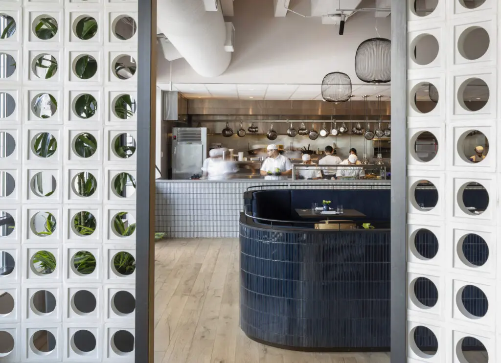 A peek inside the open kitchen from the dining room of Navy Blue in Rice Village shows its restaurant power. (Photo by Julie Soefer)