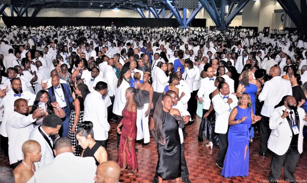 Partygoers attending the Grand Orchid Ball held during the Phi Beta Sigma international conclave at the George R. Brown Convention Center.