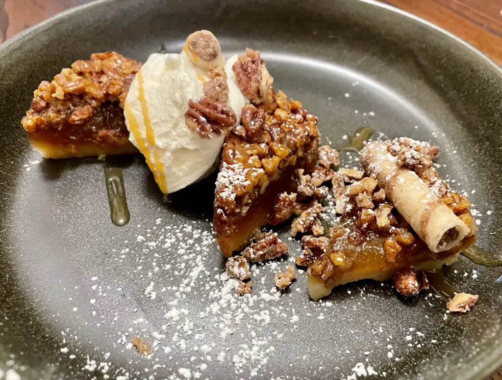 Pecan bar plated with salted caramel drizzle and fresh whipped cream. (Photo by Courtney Dabney)