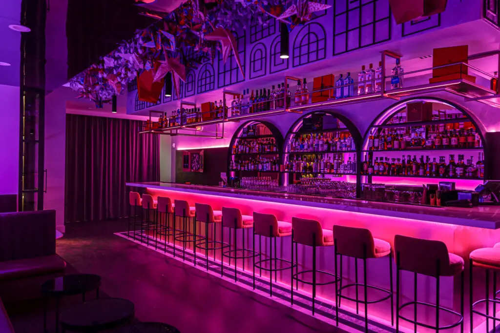 Norigami features a concealed component too. In this case, a dimly lit speakeasy, situated on the other side of a fluted wood paneled wall in the main dining room. (Photo by Jenn Duncan)