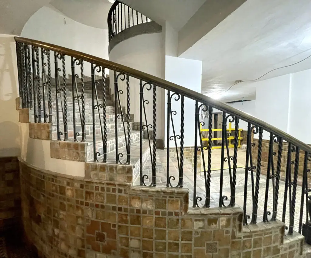 The spiral staircase leading to the lobby fitted with its original wrought iron and tile work. (Photo by Courtney Dabney)