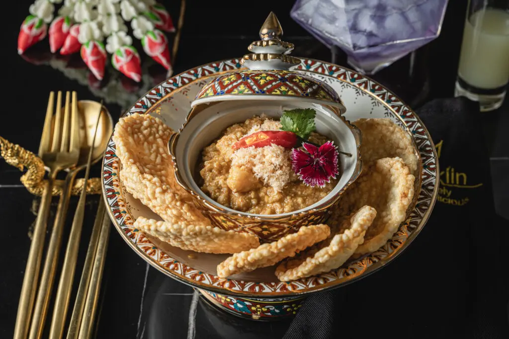 "Crispy Delights Unleashed" is made with crunchy rice crackers created in-house and topped with minced prawns and chicken, dried shrimp floss, and chopped peanuts. Photo by Sean Rainer.