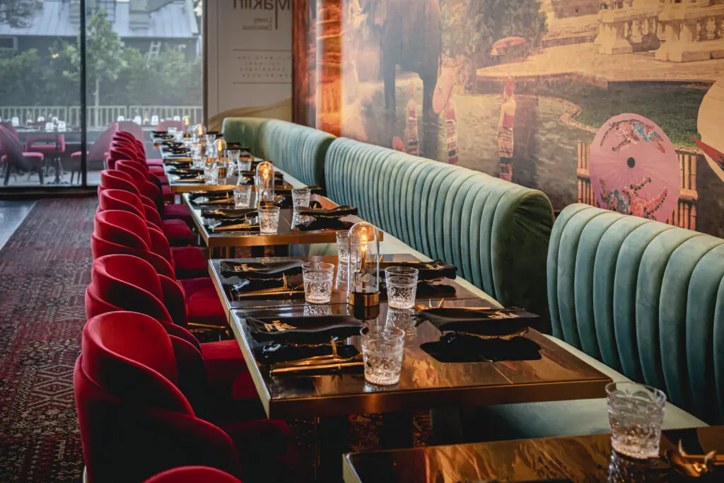 At MaKiin, designer Gin Braverman of Gin Design Group captures the exotic essence of Thailand through color-soaked, three-dimensional murals of glittering temples and lively night markets. (Photo by Sean Rainer)