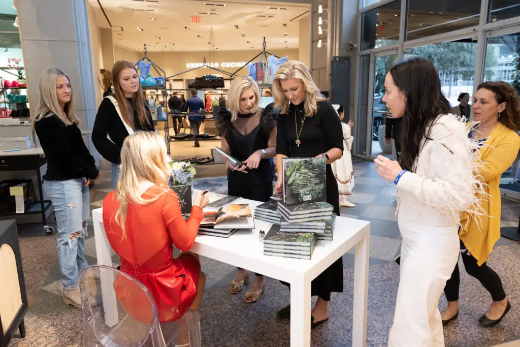 Katie Dixon signing copies of her cookbook (Photo by George Fiala)
