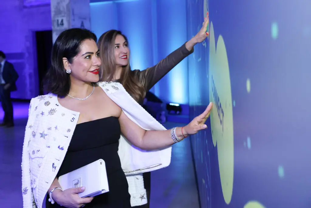 Elia Gabbanelli and a friend interact with the Heart Strings exhibit at POST Houston (Photo by Priscilla Dickson)