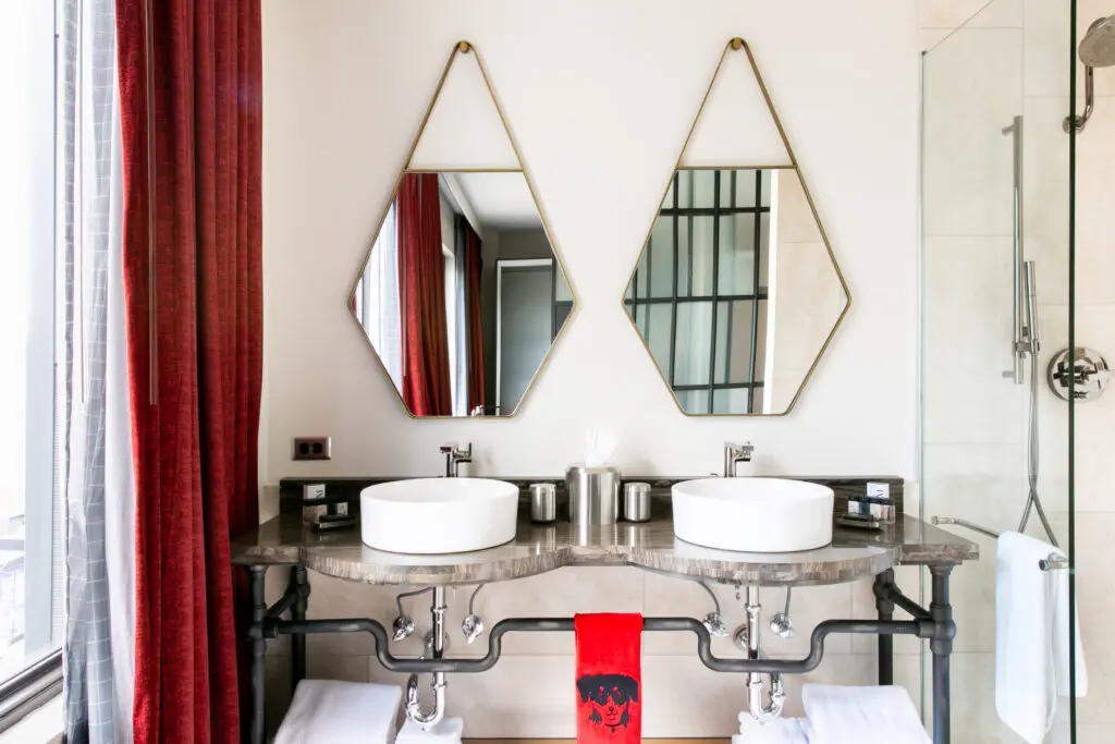 Each bathroom at Bobby Nashville features glass pane walls and William Roam bath products. (Photo by Lisa Diederich Photography)