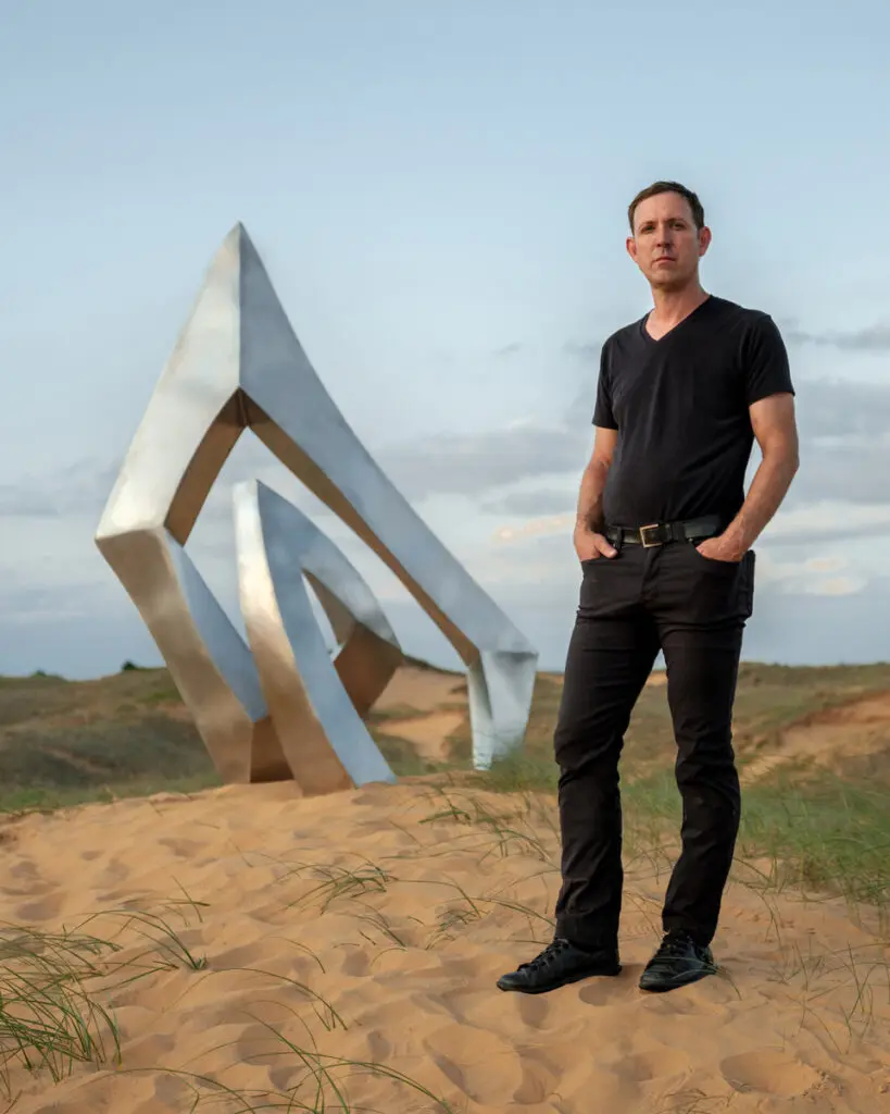 Artist Morgan Robinson (pictured here with his “Nestle” sculpture, has adopted Houston as his art base.