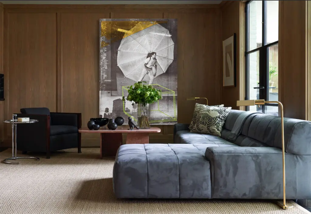 In the family room, Robert Rauschenberg lithograph from triptych "Autobiography," 1968. Marble table from Found. Bill Sofield for Baker armchair in Rogers & Goffigon mohair, Eileen Gray table from Knoll. Sofa from Chairish. Robert Motherwell work on paper from Lewis & Maese Antiques & Auctions. (Photo by Pär Bengtsson)
