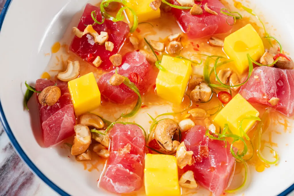 The Even Coast raw menu features big eye tuna crudo, yellowtail crudo, and oysters. (Photo by Jasonbyg Photography)