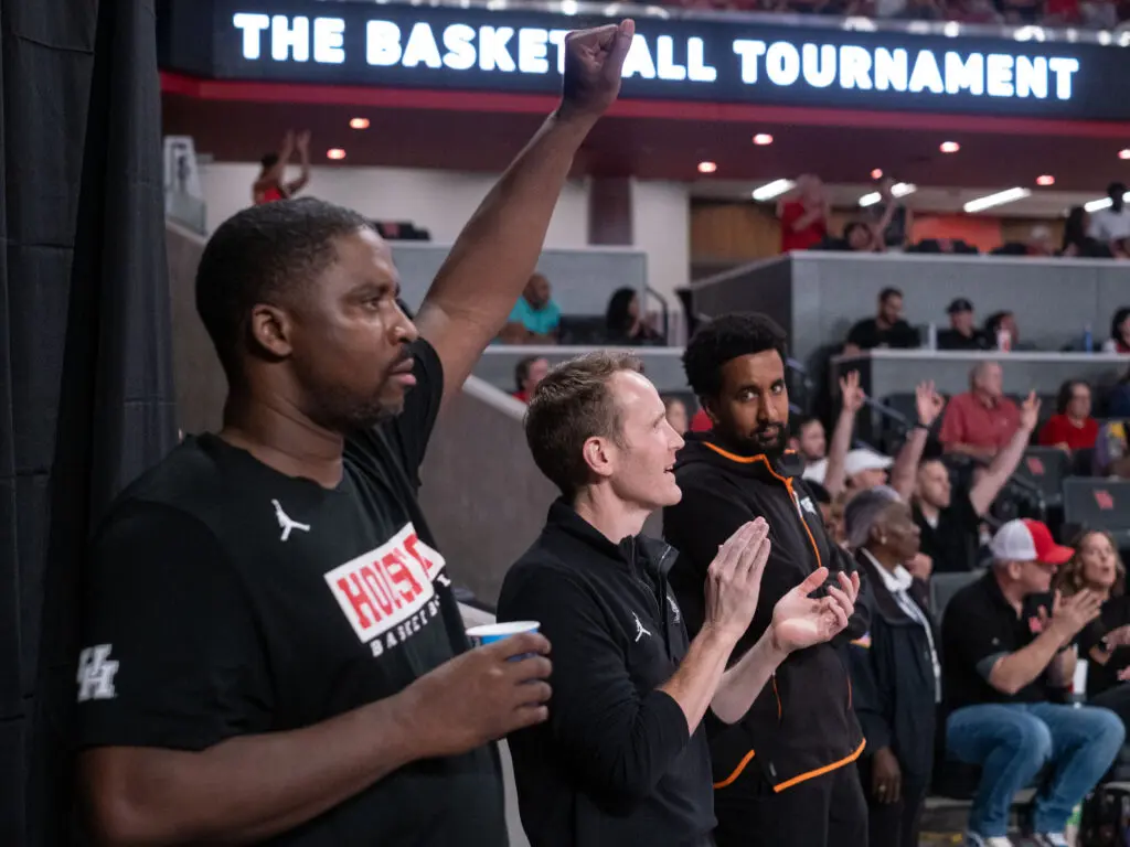 University of Houston basketball assistant coaches Quannas White and K.C. Beard love to cheer on their former players. (Photo by F. Carter Smith)