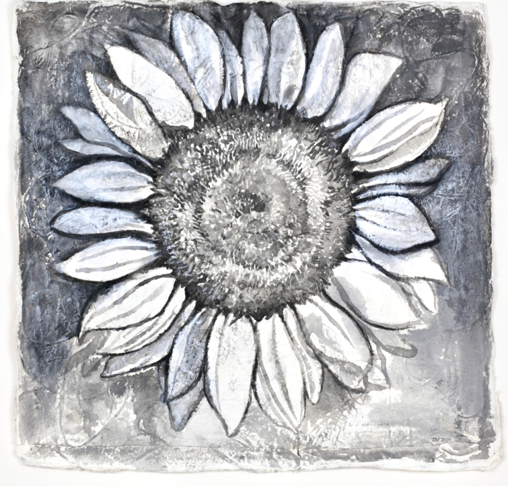 Multidisciplinary artist Lydia Bodnar-Balahutrak's sunflower painting invites viewers in with its contrast at Andrew Durham Gallery, as part of the “Side by Side, 20 x 20: Honduras Threads” exhibition.