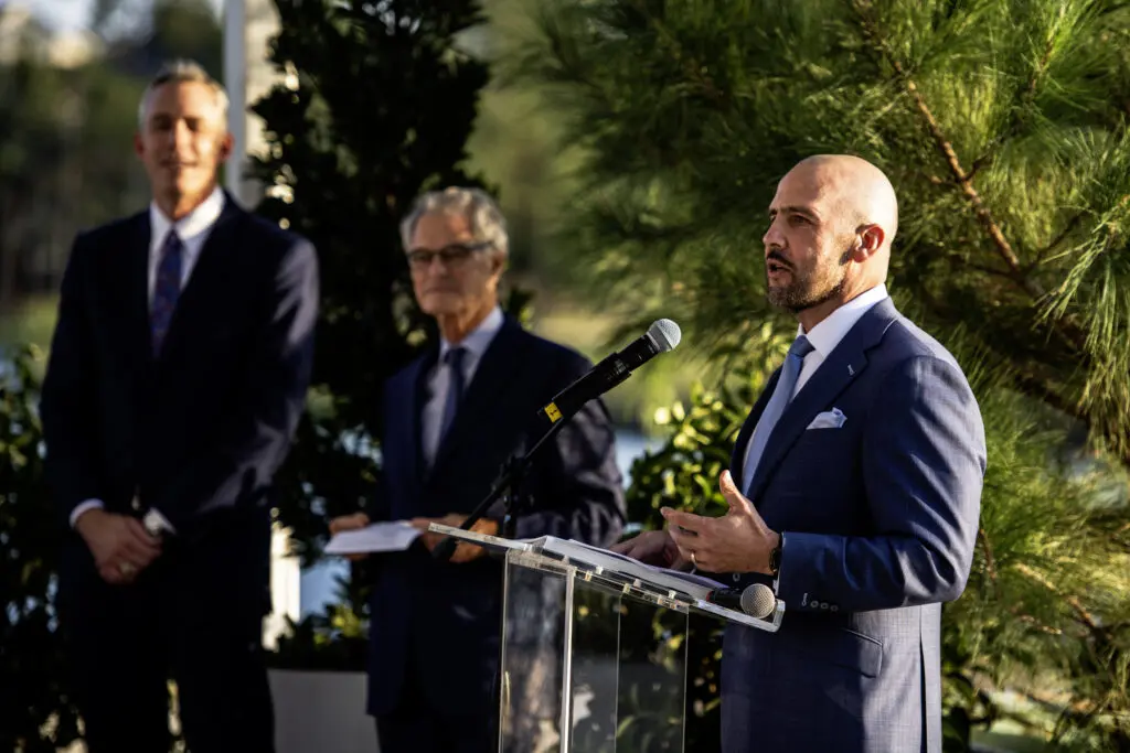 Howard Hughes CEO David Reilly (at podium) with Jim Carman (left) and Jay Cross of Howard Hughes at the groundbreaking ceremony. 